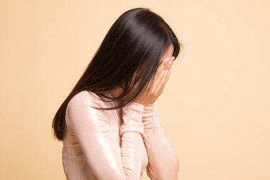 Üzgün genç Asyalı kadın avuç içi ağlar.