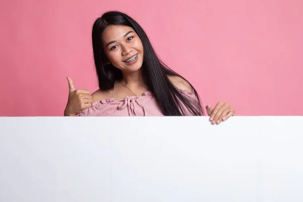 Junge asiatische Frau zeigen Daumen nach oben mit leeren Zeichen. — Stockfoto