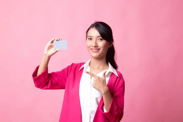 Young Asian woman point to a blank card.