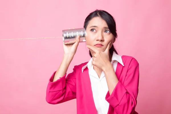 Young Asian woman hearing with tin can phone and thinking. — Stock Photo, Image