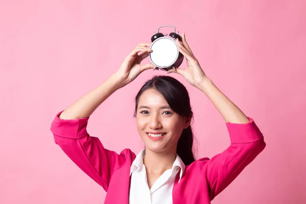 Young Asian woman smile with a clock. — Stock Photo, Image
