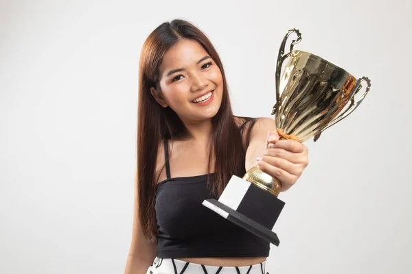 Successful young asian woman holding a trophy.