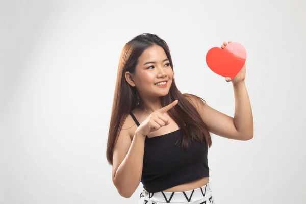 Asian woman point to red heart.