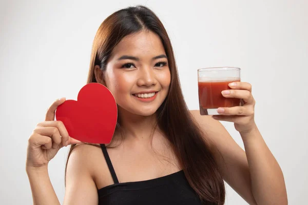 Joven mujer asiática con jugo de tomate y corazón rojo . — Foto de Stock