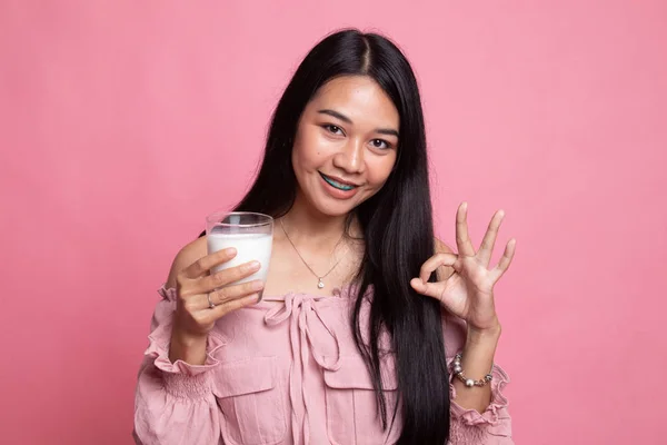 Healthy Asian woman drinking a glass of milk show OK sign. — Stock Photo, Image