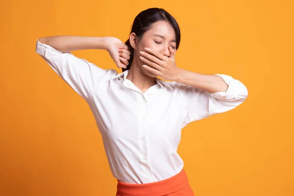 Sleepy young Asian woman yawn.