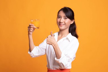 Genç Asyalı kadın başparmak yukarıya içki portakal suyu.