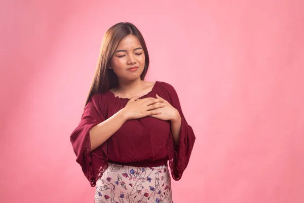 Young Asian woman got chest pain.