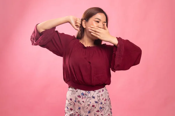 Sleepy young Asian woman yawn.