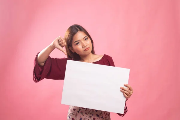 年轻的亚裔女子将拇指下来带白色空白标志. — 图库照片