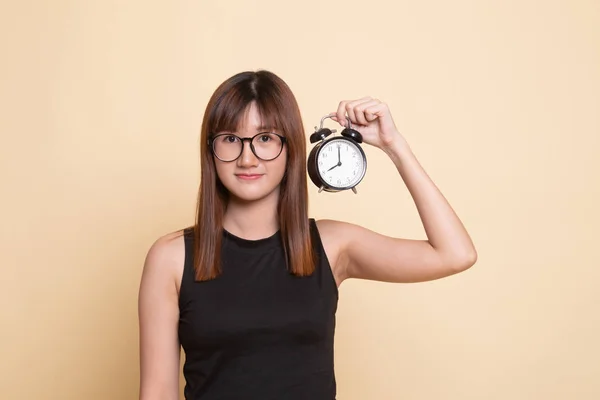 Young Asian woman with a clock. — Stock Photo, Image