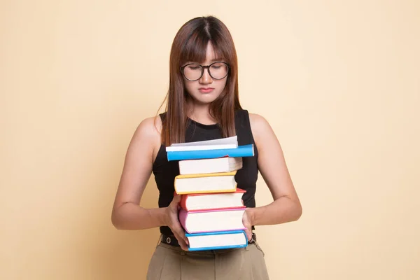 Unhappy young Asian woman studying  with may books. — Stock Photo, Image