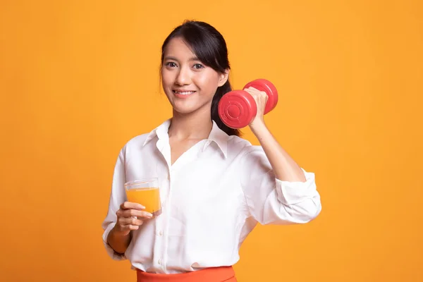 Young Asian woman with dumbbell drink orange juice. — Stock Photo, Image