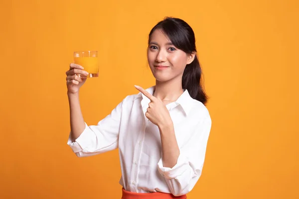 Jovem mulher asiática apontar para suco de laranja . — Fotografia de Stock