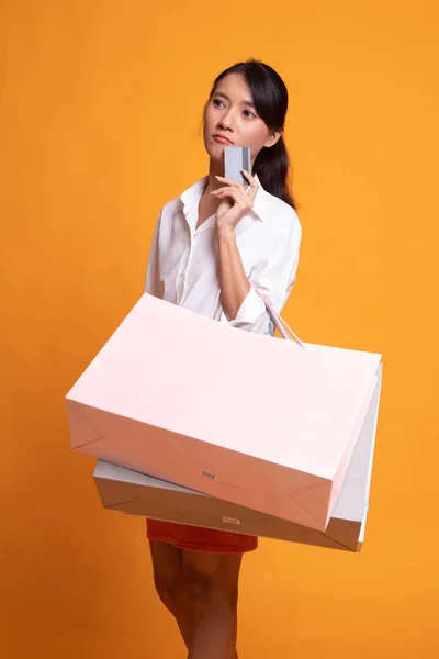 Mujer asiática joven con bolsa de compras y tarjeta en blanco . — Foto de Stock