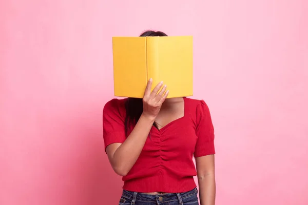 Joven asiática mujer con un libro cubrir su cara . — Foto de Stock