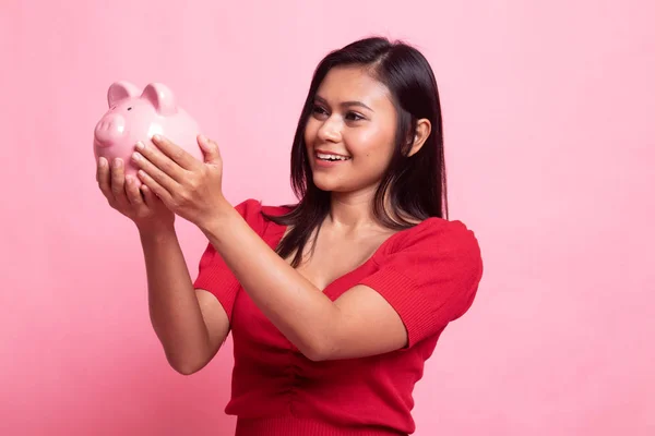 Young Asian woman with a pig coin bank. — Stock Photo, Image