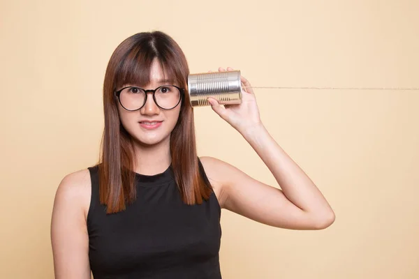 Young Asian woman with tin can phone. — Stock Photo, Image