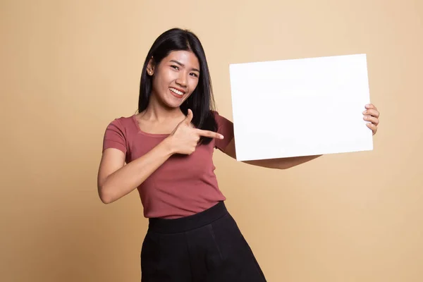 Young Asian woman point to  blank sign.