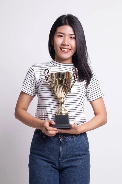 Successful young asian woman holding a trophy.