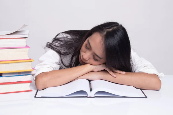 Exhausted Young Asian woman sleep with books on table. — Stock Photo, Image
