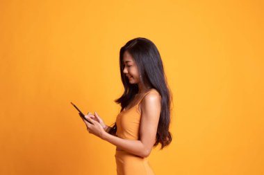 Bir bilgisayar tablet ile genç Asyalı kadın.