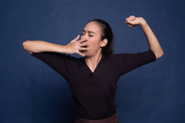 Sleepy young Asian woman yawn.