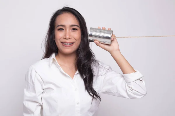 Young Asian woman with tin can phone. — Stock Photo, Image