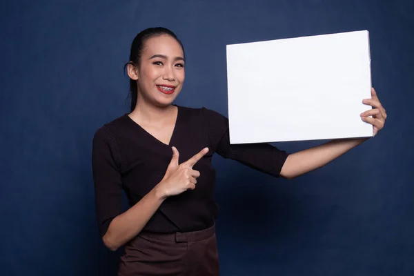 Young Asian woman point to  blank sign.