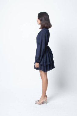 Güzel genç Asyalı kadının beyaz arka plan üzerinde yan tam vücut