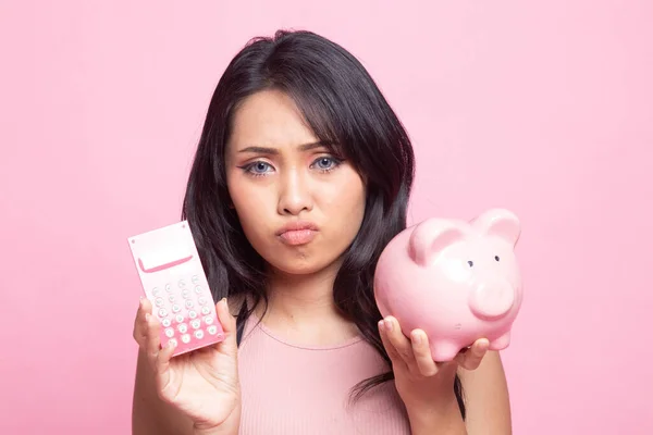 Unhappy Asian Woman Calculator Piggy Bank Pink Background — Stock Photo, Image