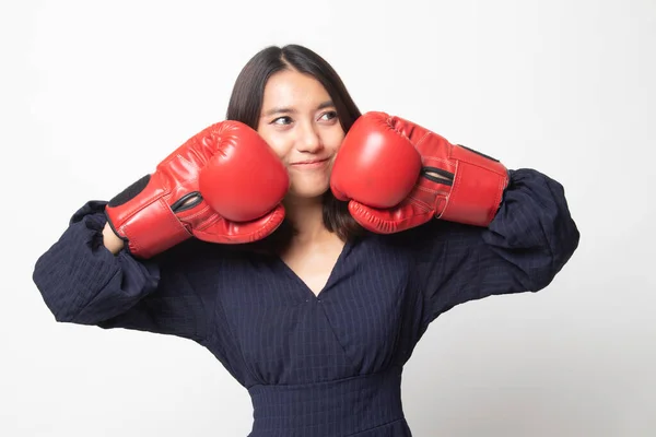 Young Asian woman with red boxing gloves on white background