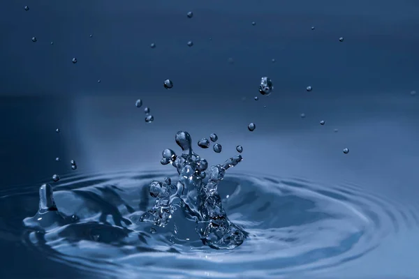 Splashing water drops causing wavy water surface