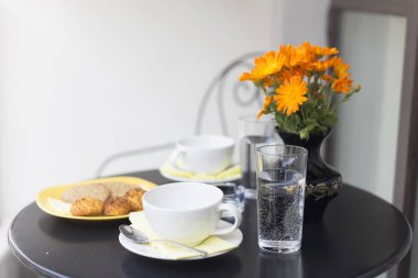 Güzel kahvaltı bir balkonda kurmak. Su, kahve ve kurabiye.