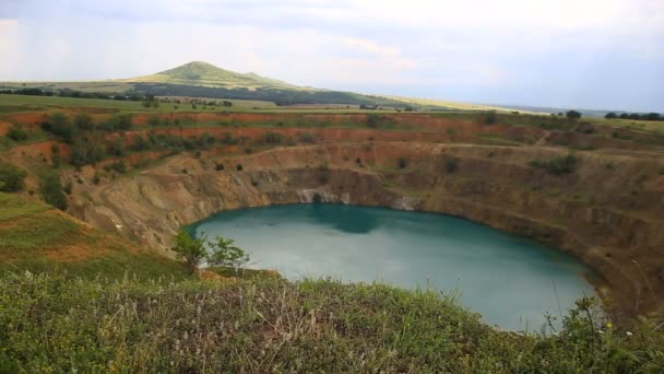 一个人看着一个巨大的火山口与人工湖泊内形成 — 图库视频影像