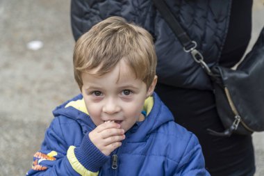 Parkta patlamış mısır yiyen küçük çocuk