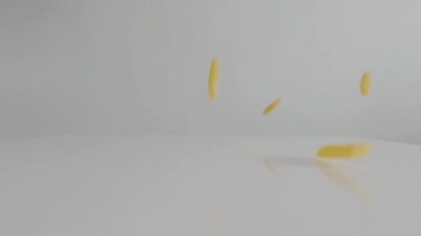 Penne pasta cayendo sobre fondo blanco — Vídeos de Stock