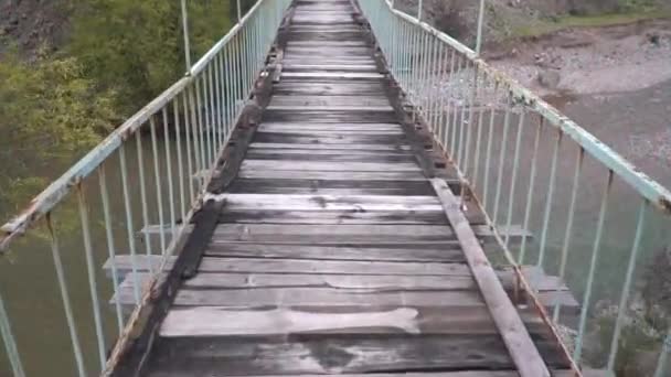 Gehen auf einer alten und gefährlichen Hängebrücke — Stockvideo