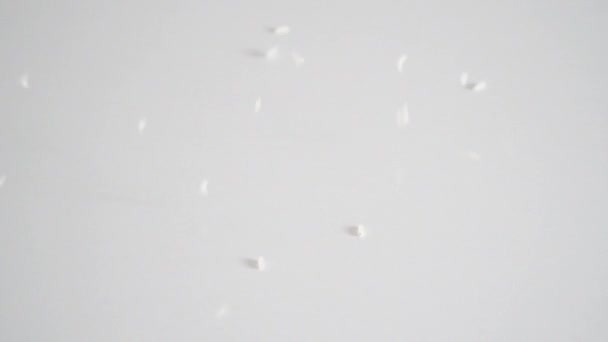 Slow motion of white rice falling on a table — Stock Video