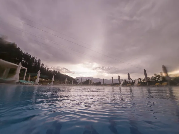 Bad weather over a big swimming pool — Stock Photo, Image