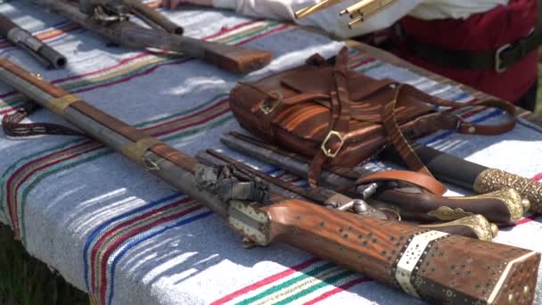 Old guns and rifles on a table — Stock Video