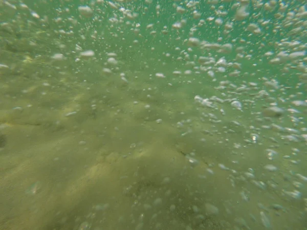 Bubbles under the water of a river
