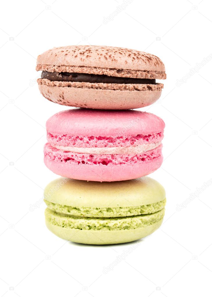 Stack of chocolate, pistachio and pink macaroon on a white background