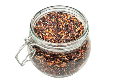 Beyaz arka plan üzerine açık cam kavanoza ham yabani pirinç