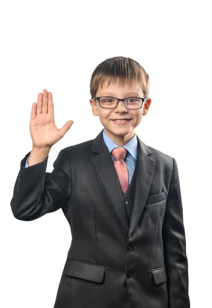 开朗的小学生用眼镜挥舞着他的手在一个白色的背景 — 图库照片