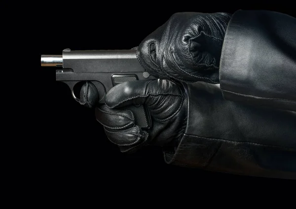 Bandit recharges gun in hands on black background