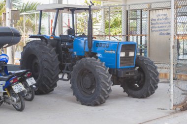 Pattaya, Thailand - May 16, 2018:  tractor LANDINI 8860 used on the beach for descent to water of small size vessels and scooters clipart