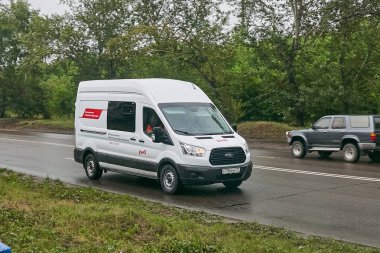 Krasnoyarsk, Rusya - 30 Temmuz 2018: Ford Transit bir yağmur ıslak yolda geçen .