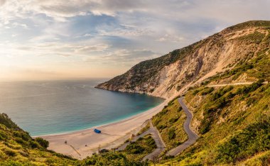 Myrthos beach seascape and serpentine road shoot at golden hour. Ionian islands, Kefalonia, Greece. clipart