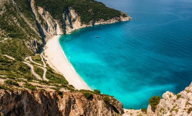 Kefalonia Adası yılan gibi yol ve turkuaz İyon Denizi ile kumsalda Myrtos.